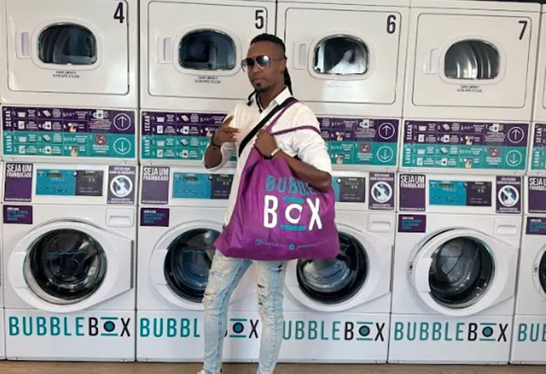 Cliente com sacola da Bubble Box em frente às máquinas